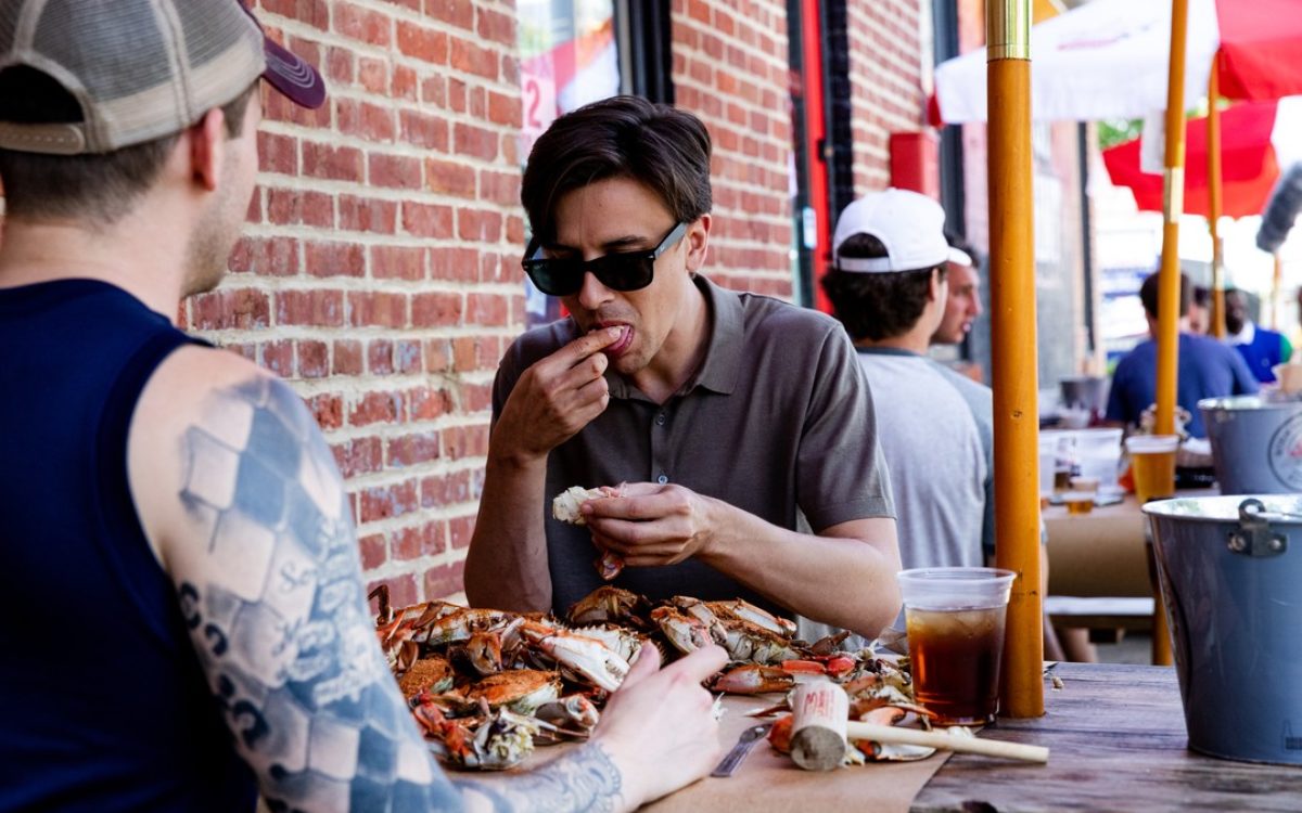 People outside eating crabs