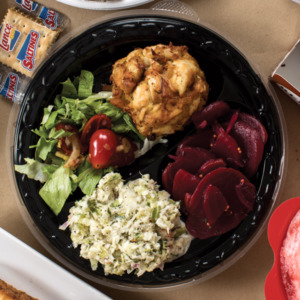 Take out container of salad, cole slaw, beets, and crab cake