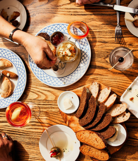aerial view of many plates on a warm wood table