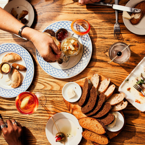 aerial view of many plates on a warm wood table
