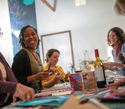 People at a table with wine at Maker Community.