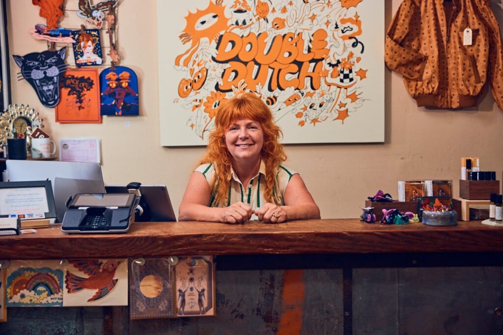 a woman smiles behind the register of doubledutch vintage