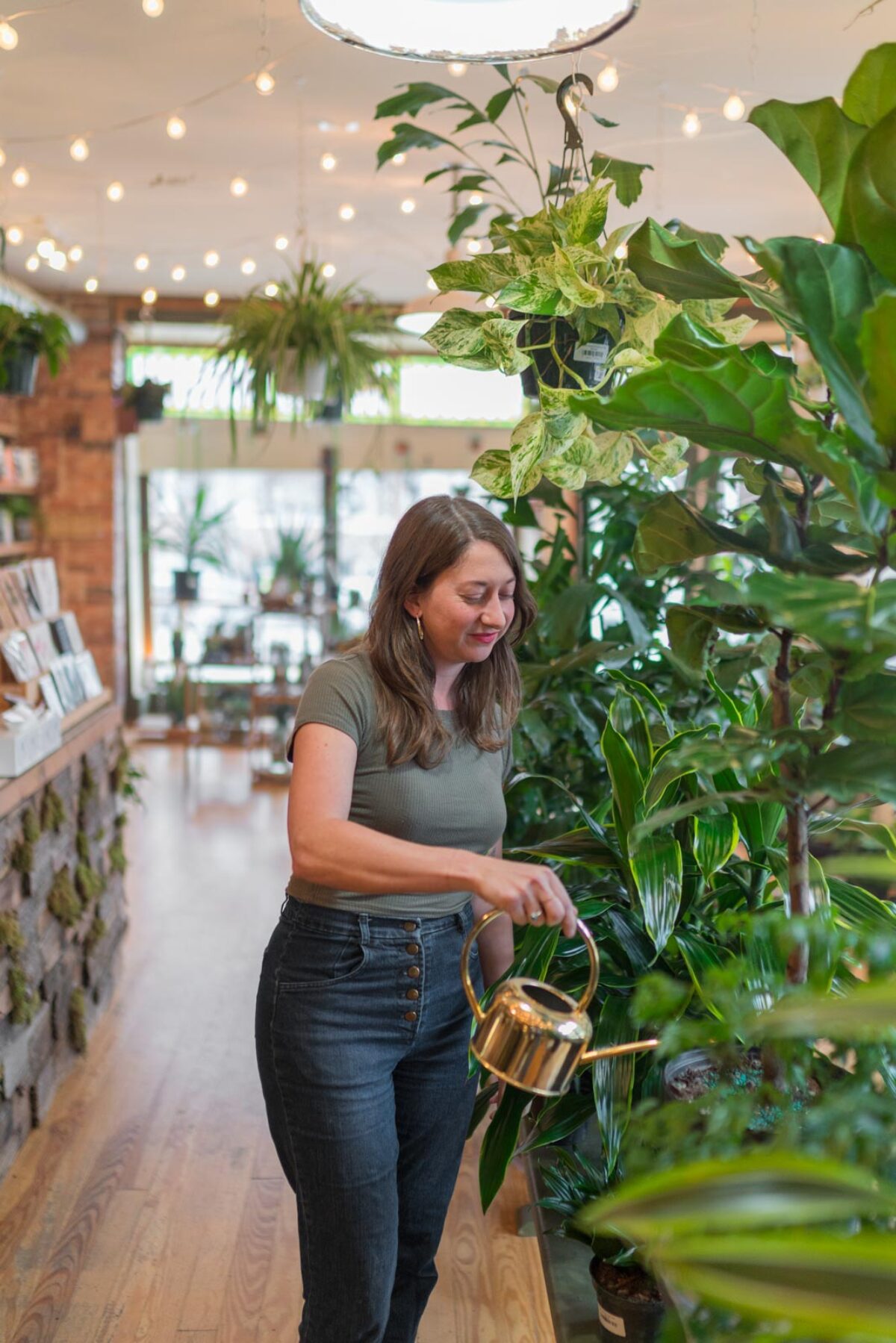 Someone waters plants at B Willow Shop in Baltimore.