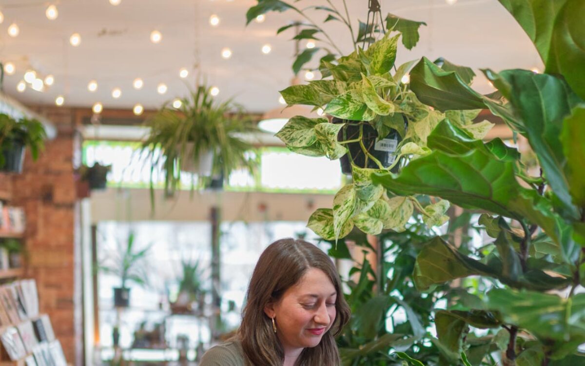 Someone waters plants at B Willow Shop in Baltimore.