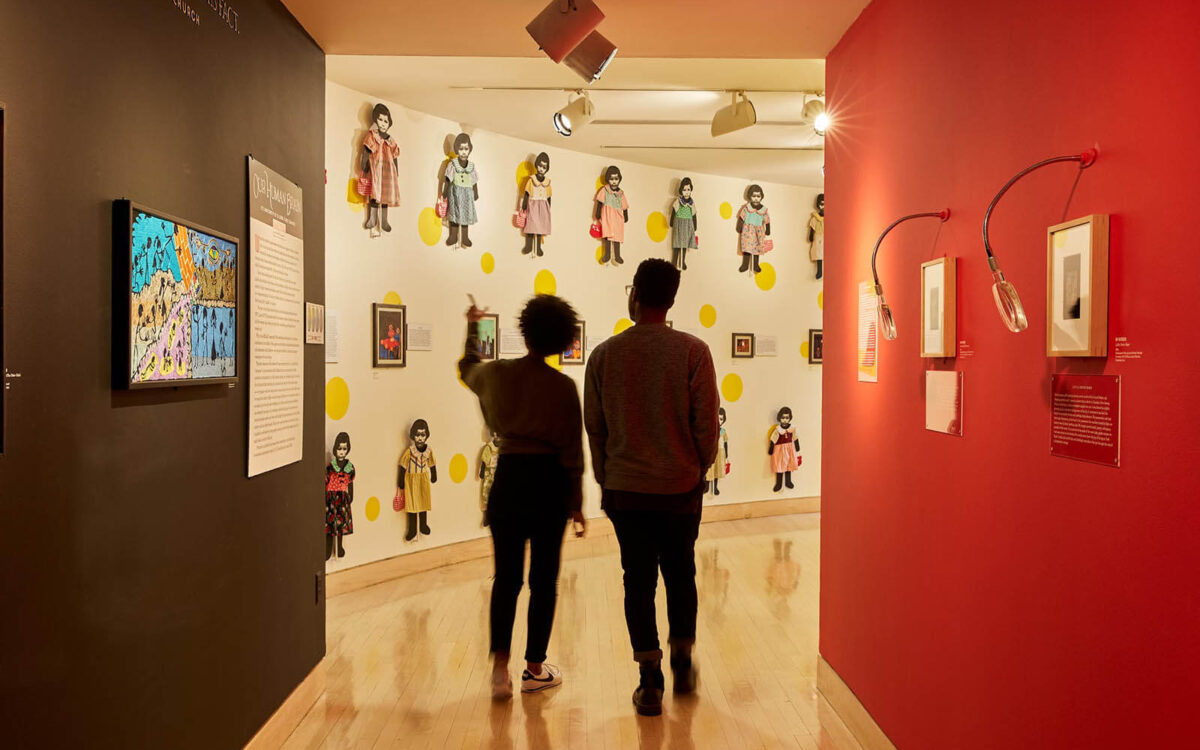 Two people look at an interior exhibition at AVAM in Baltimore.