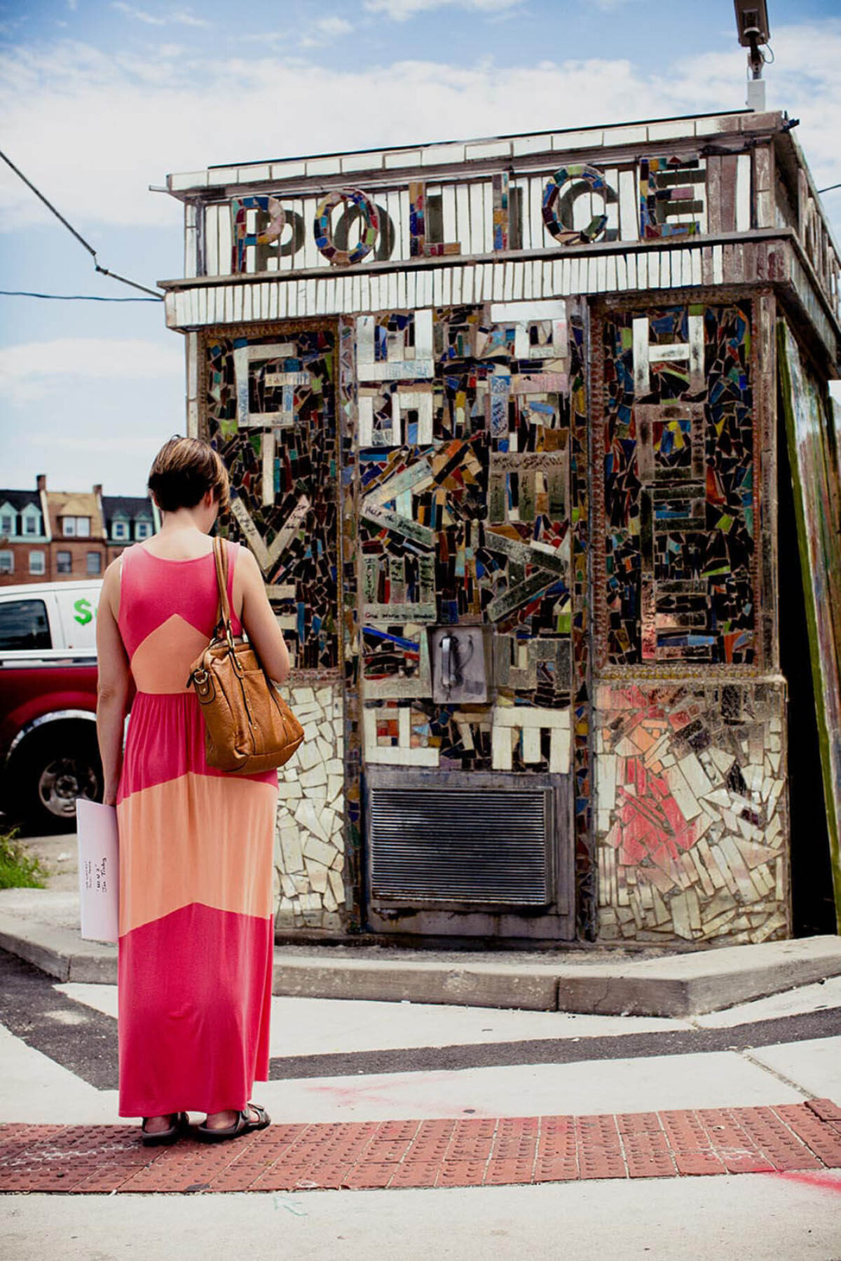 An onlooker stops to look at a mosaic in Baltimore during Artscape.