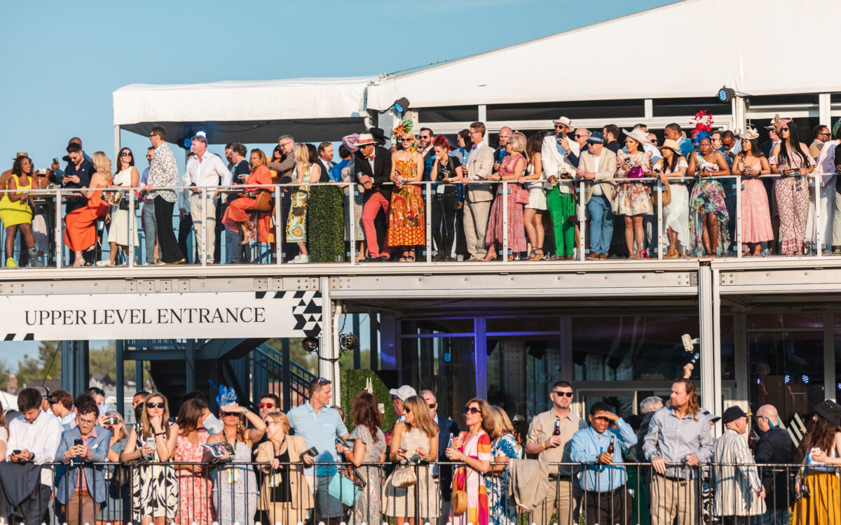 people watch the Preakness Stakes from the terrace