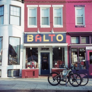 Exterior of Balto on The Avenue, which has a pink building and bikes parked out front. 