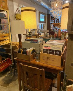 Old records sit on a light wooden desk in Rust-n-Shine in Baltimore