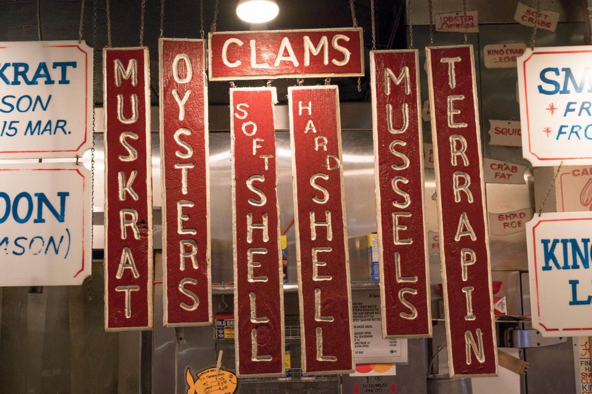 Red and white hand crafted vintage signage at Faidleys in Lexington Market in Baltimore.