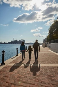 A family walks along the promenade in Baltimore's Inner Harbor.