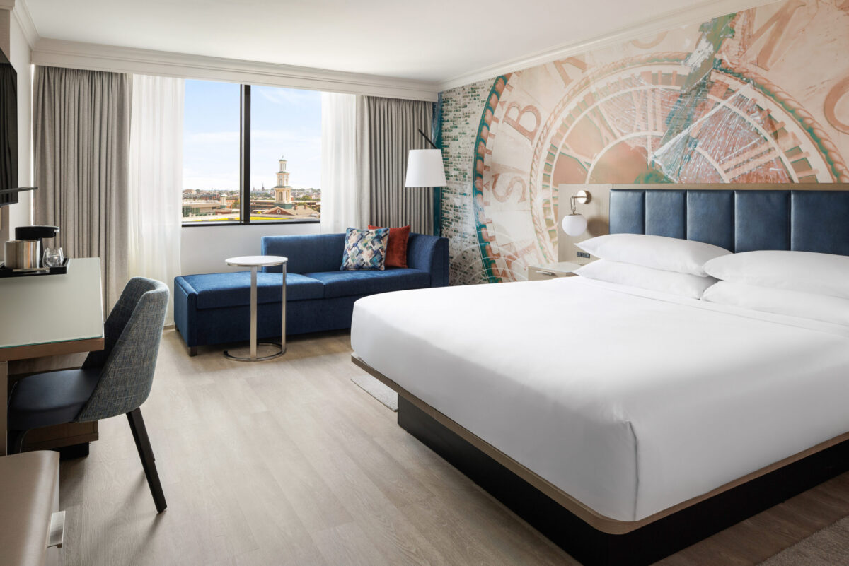 The newly renovated King Room offers a stylish and comfortable retreat with modern furnishings, plush bedding, luxury vinyl flooring, a spacious workstation, and convenient amenities including a 55-inch Smart TV with streaming, mini-refrigerator, coffee maker, and high-speed Wi-Fi.