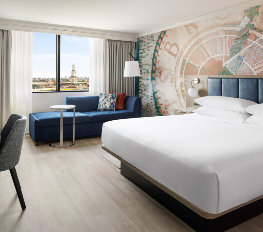 The newly renovated King Room offers a stylish and comfortable retreat with modern furnishings, plush bedding, luxury vinyl flooring, a spacious workstation, and convenient amenities including a 55-inch Smart TV with streaming, mini-refrigerator, coffee maker, and high-speed Wi-Fi.