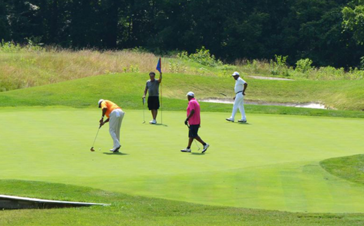 A group of men playing golf