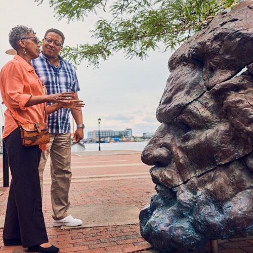 2 people looking at a sculpture