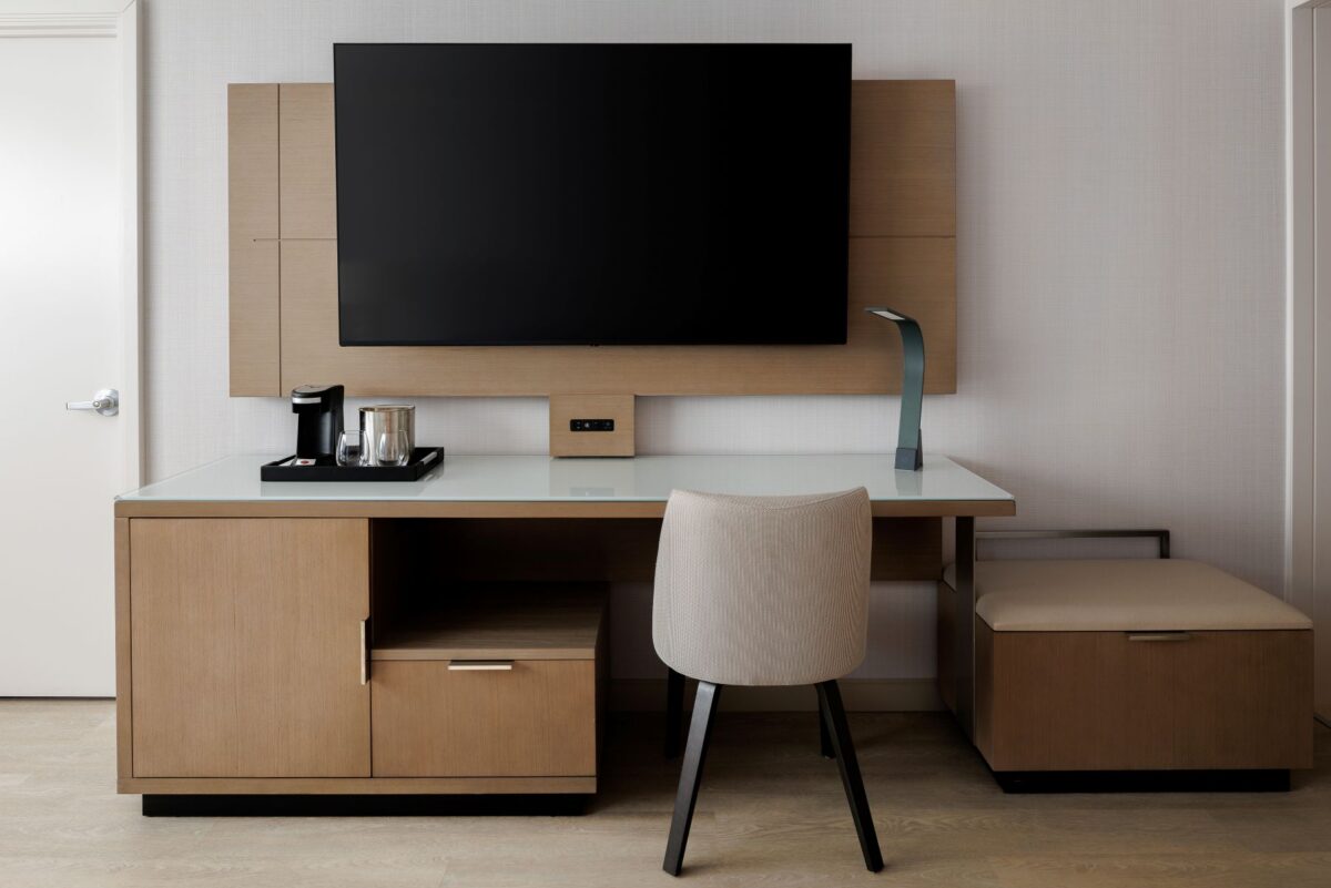 Stay productive in a thoughtfully designed workspace featuring a spacious desk, comfortable chair, task lighting, and convenient storage. A 55-inch TV and dedicated coffee station add convenience, creating a functional and comfortable space for business and leisure travelers.