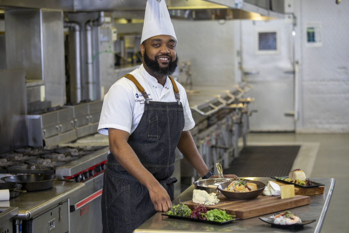 Executive Chef Gregory Pittman poses with a lavish dish in the Centerplate kitchen
