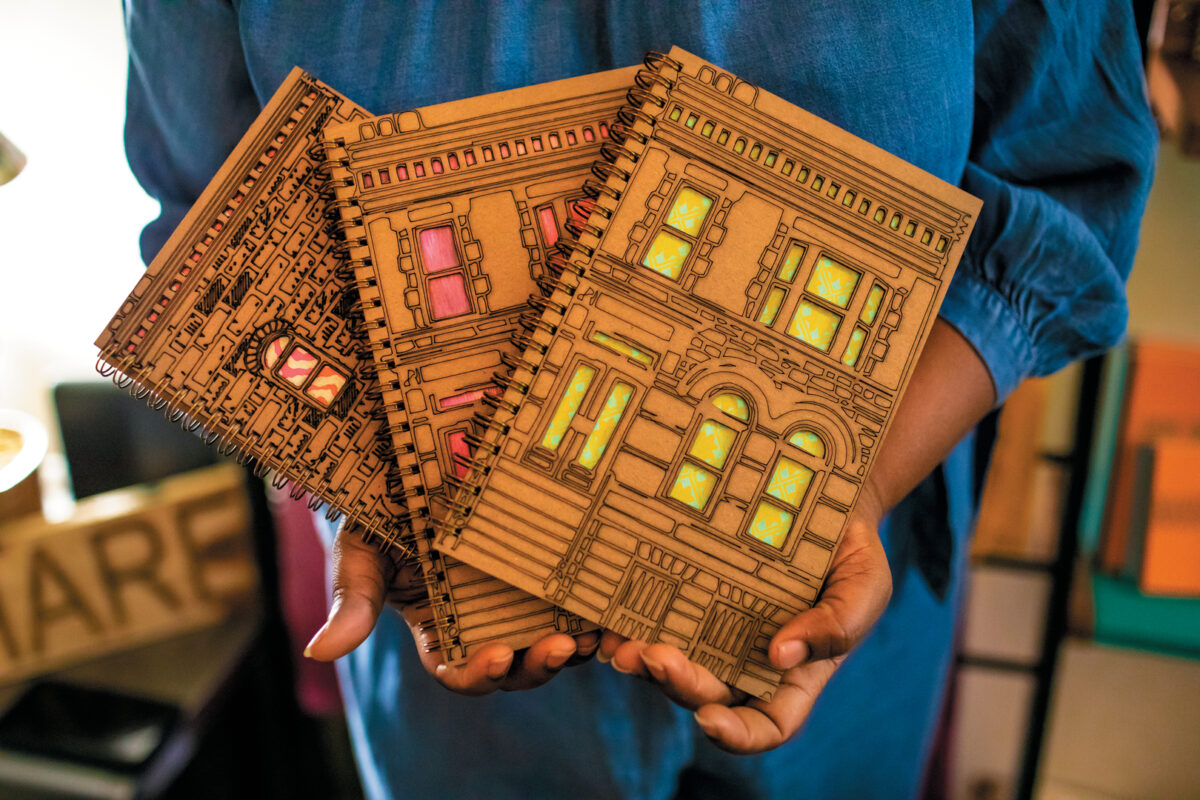 Woman holds brown journals