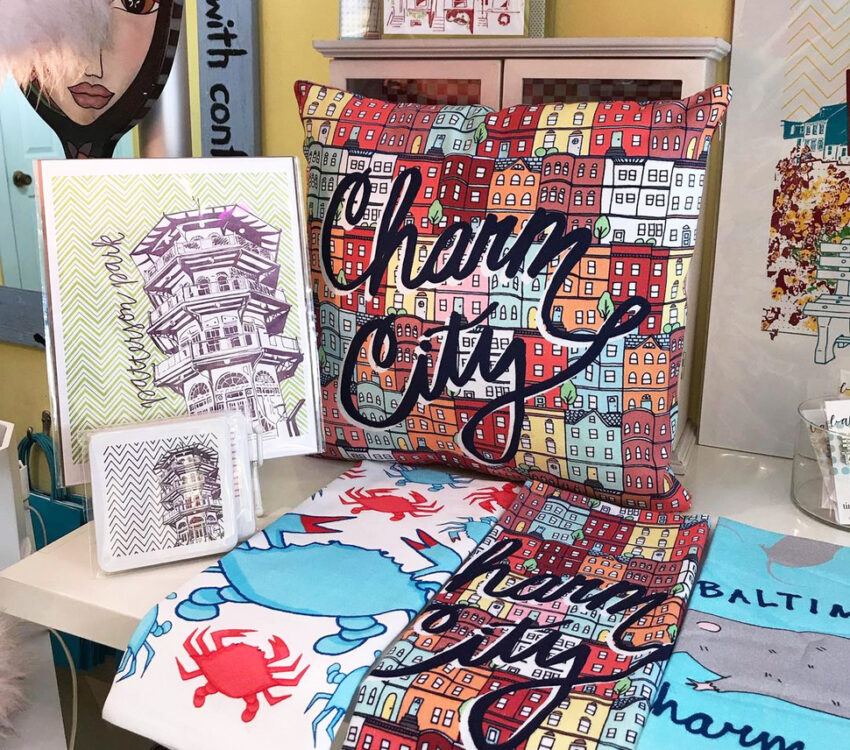 Pillow and napkins with crabs that say Charm City