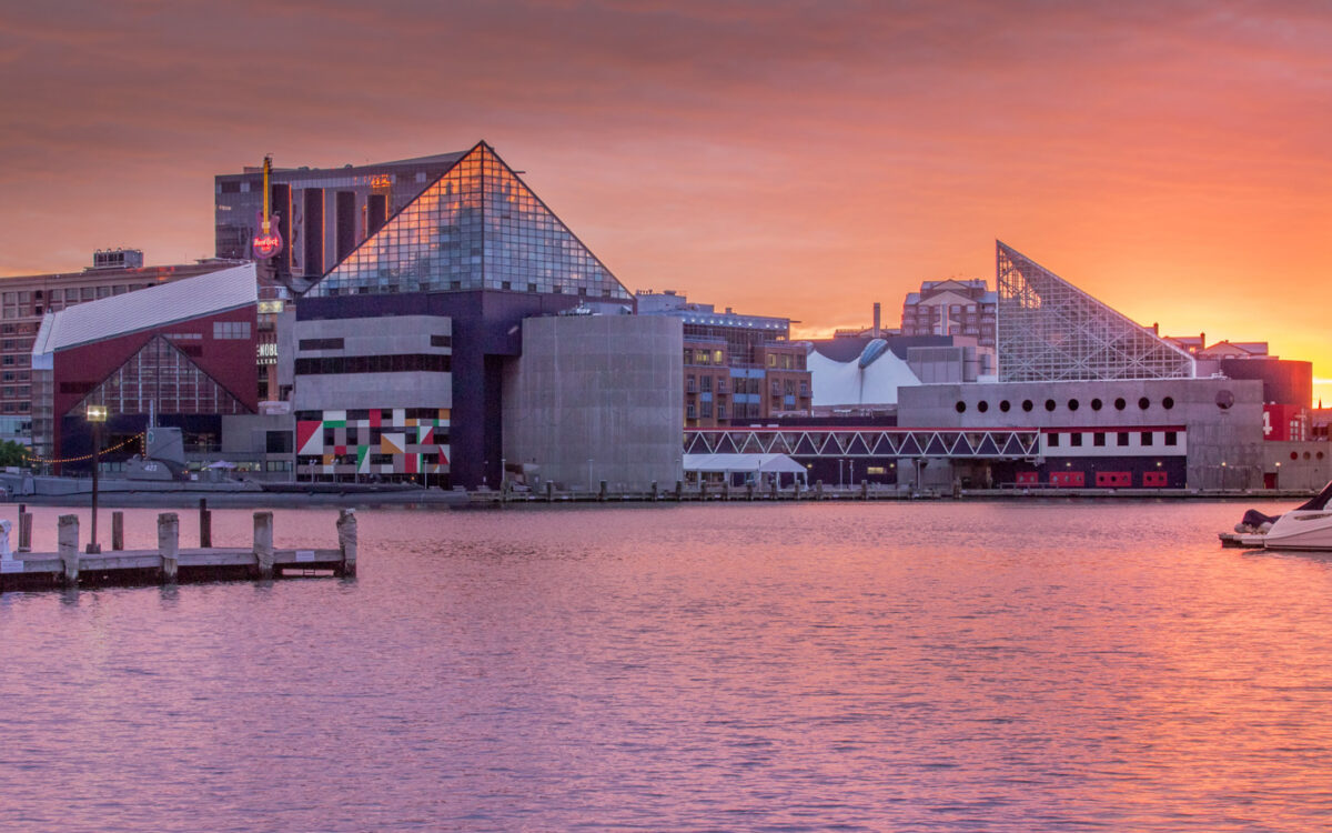 Exterior of the the National Aquarium at sunset seen from the harbor.
