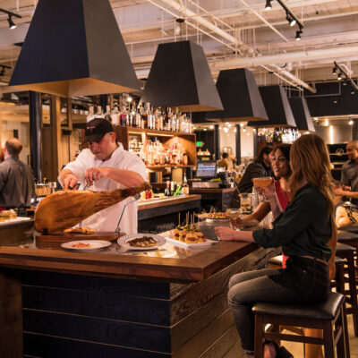 interior restaurant showing a bar with people seated at stools