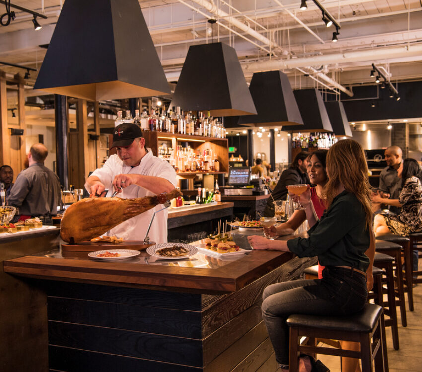 interior restaurant showing a bar with people seated at stools
