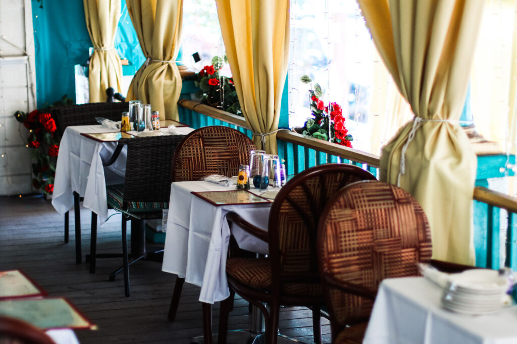 Tables with white linen table cloths lined up in a row