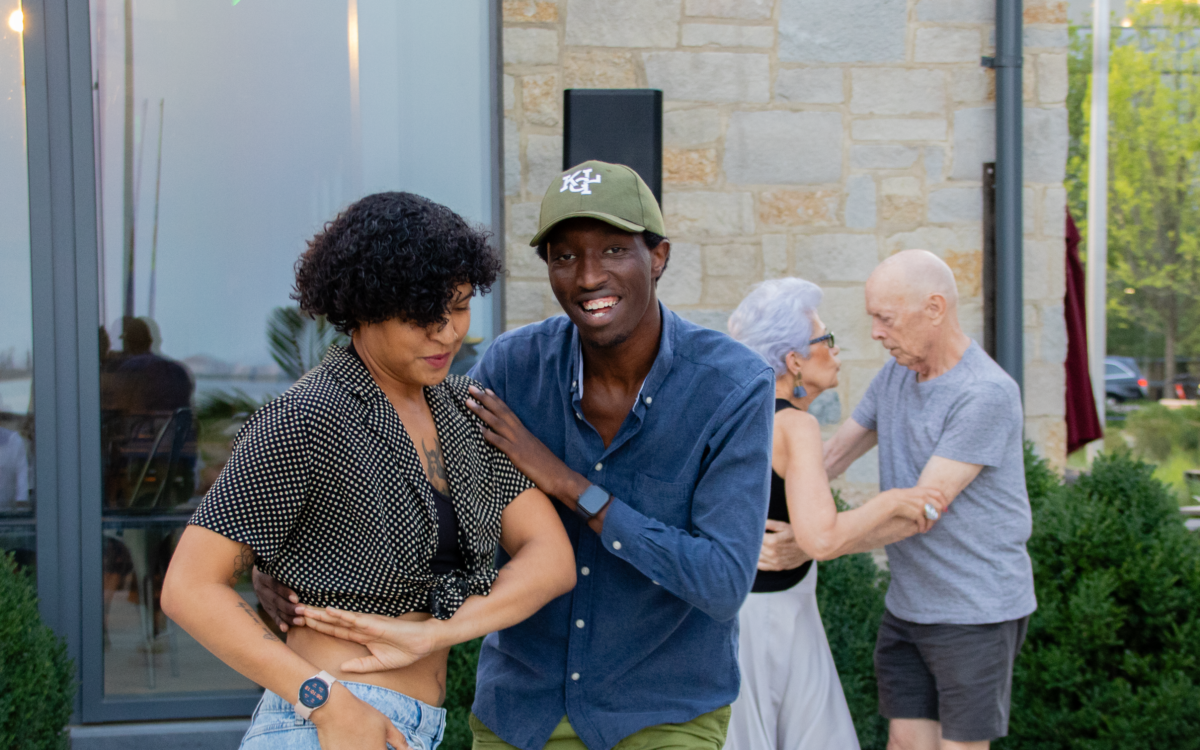 A woman and man dance together