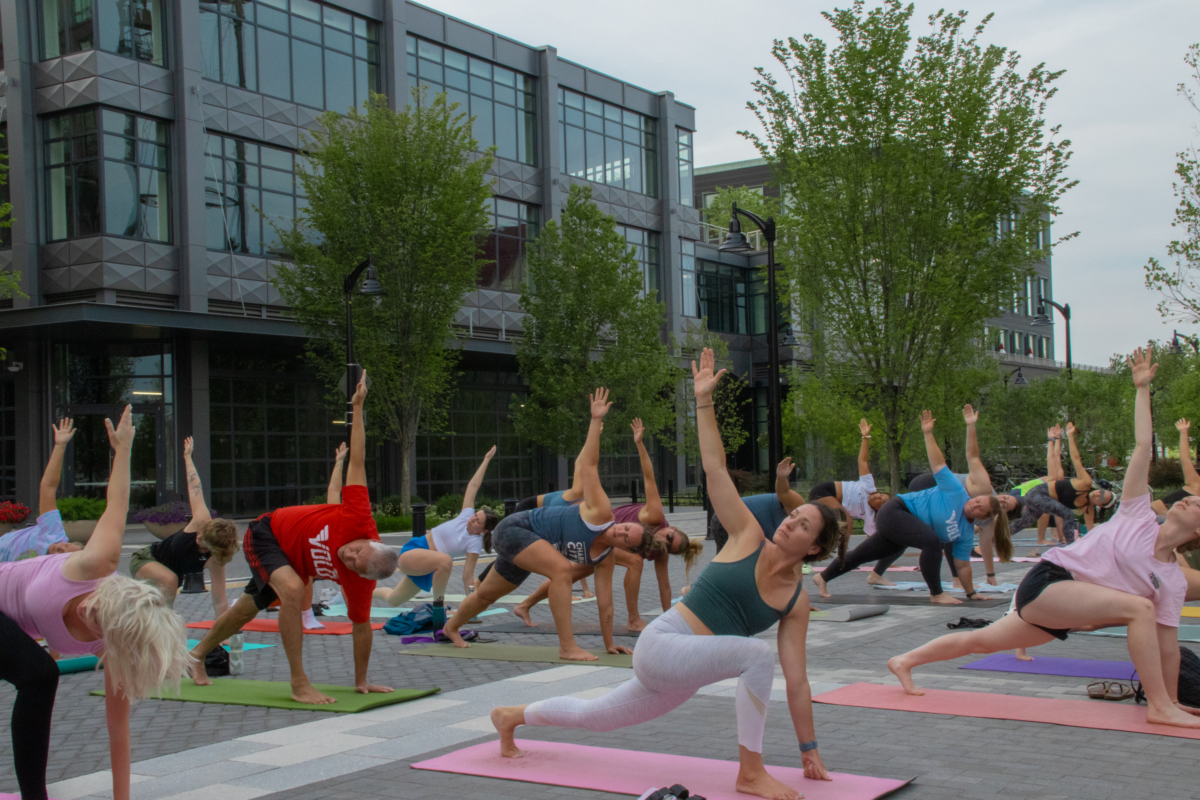 A group of people doing yoga outdoors