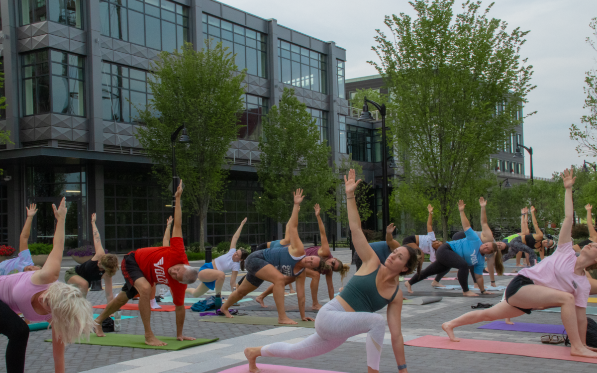 A group of people doing yoga outdoors