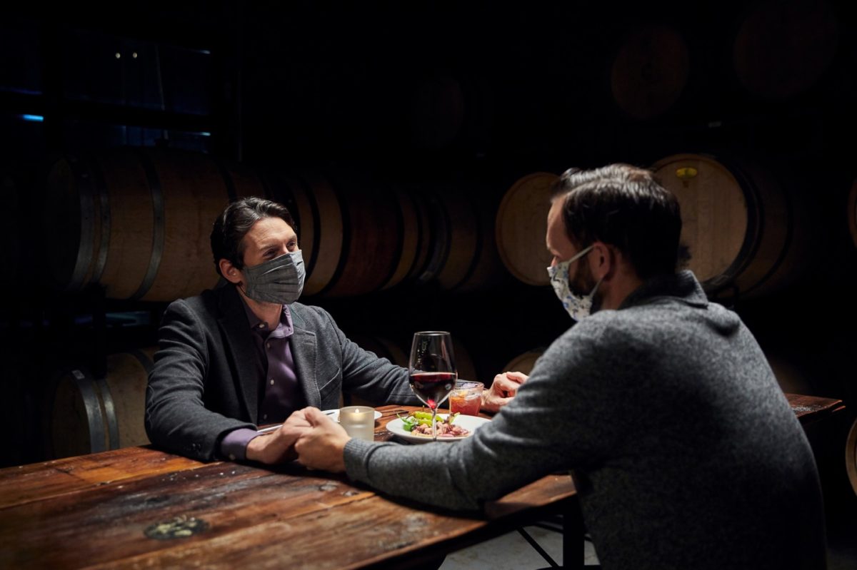 Two men enjoy a romantic meal at the Wine Collective