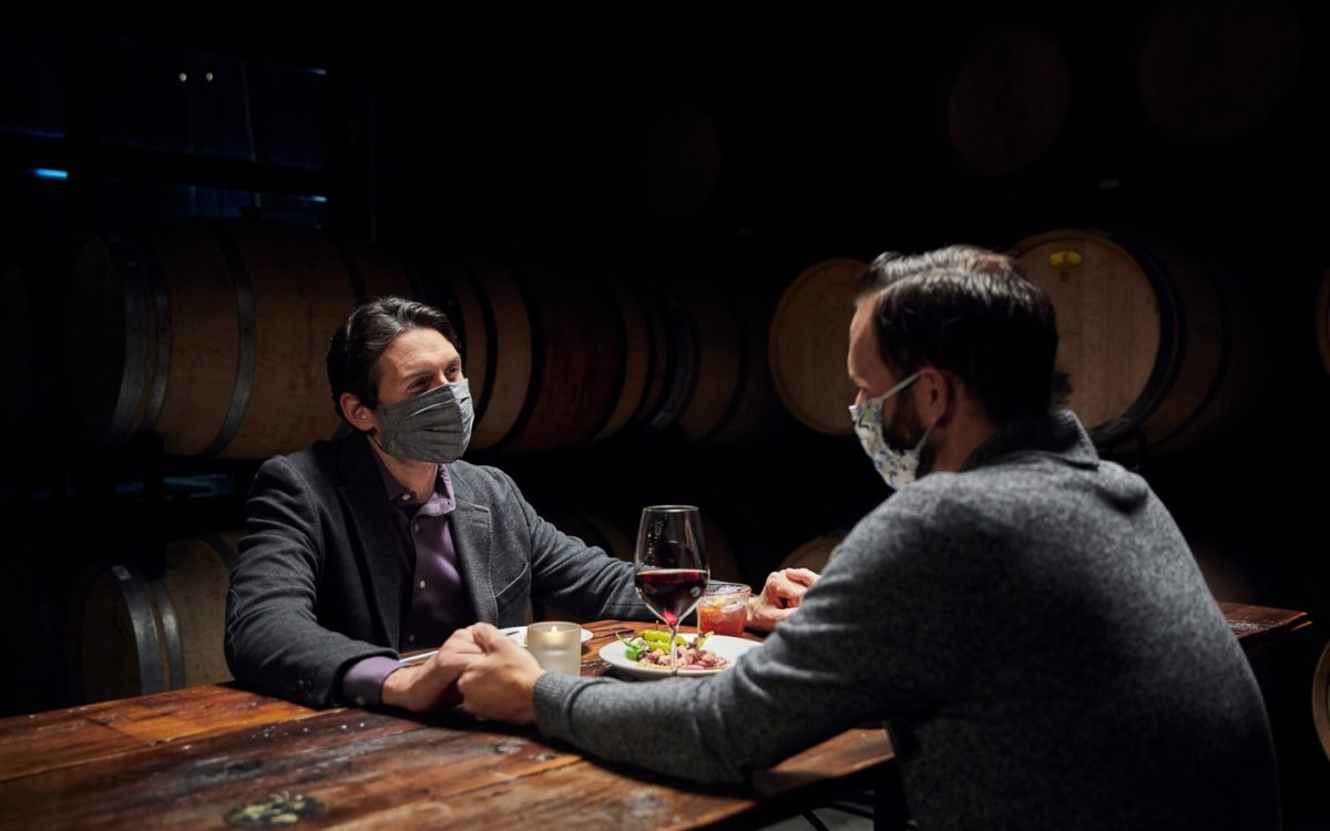 Two men enjoy a romantic meal at the Wine Collective