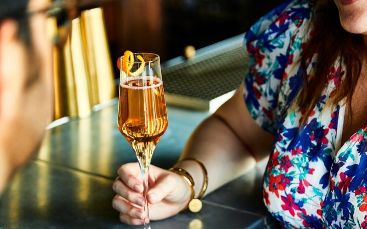 Two people holding hands with cocktail