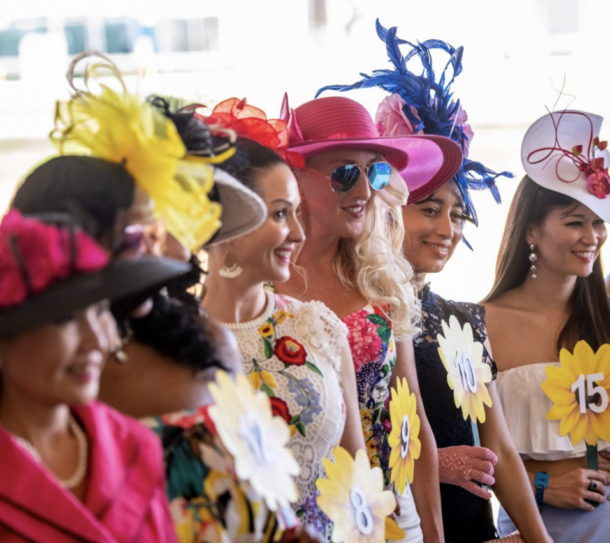 Women wearing fancy hats at the preakness