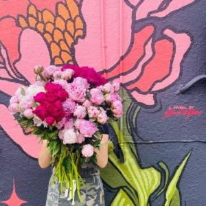Woman holds pink bouquet of flowers