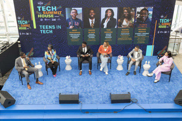 Panelists on stage at a tech summit