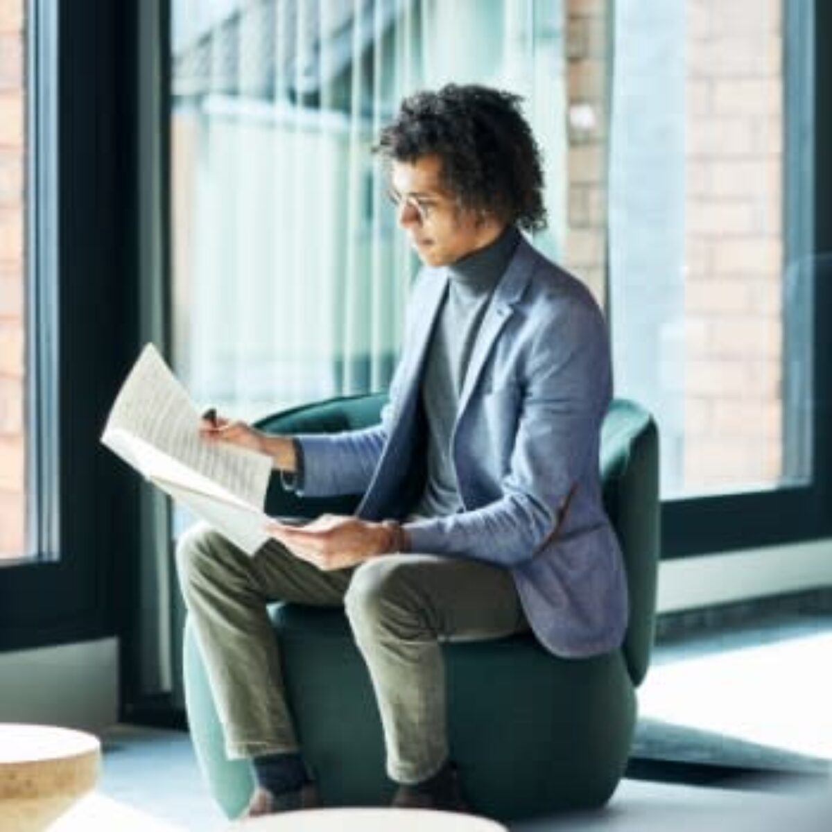 Man Reading Music in a Chair
