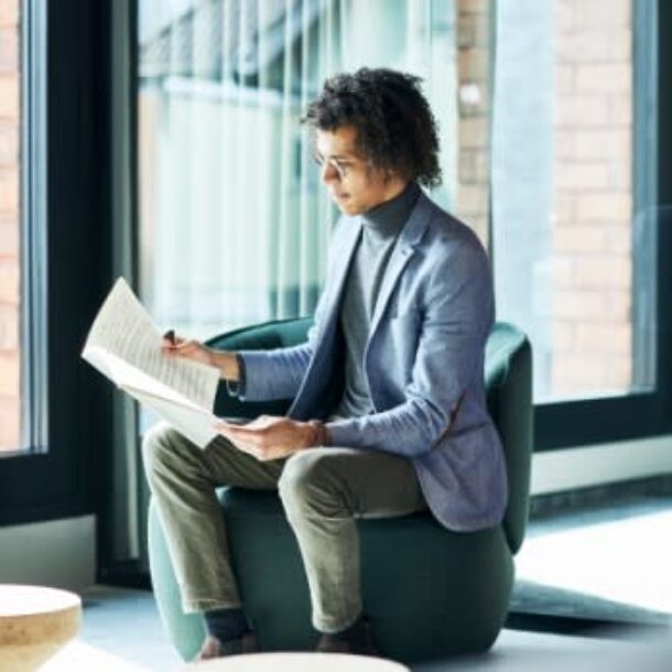 Man Reading Music in a Chair