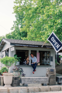 The owners of The Peggy snowball stand pose outside it