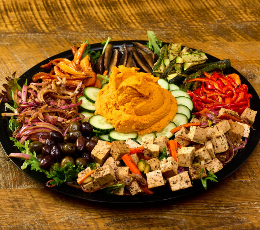 A delicious assortment of roasted vegetables, smoked hummus, and tofu salad.