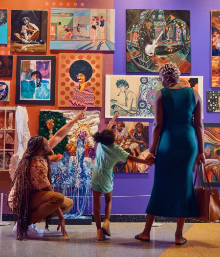 family in front of wall of art