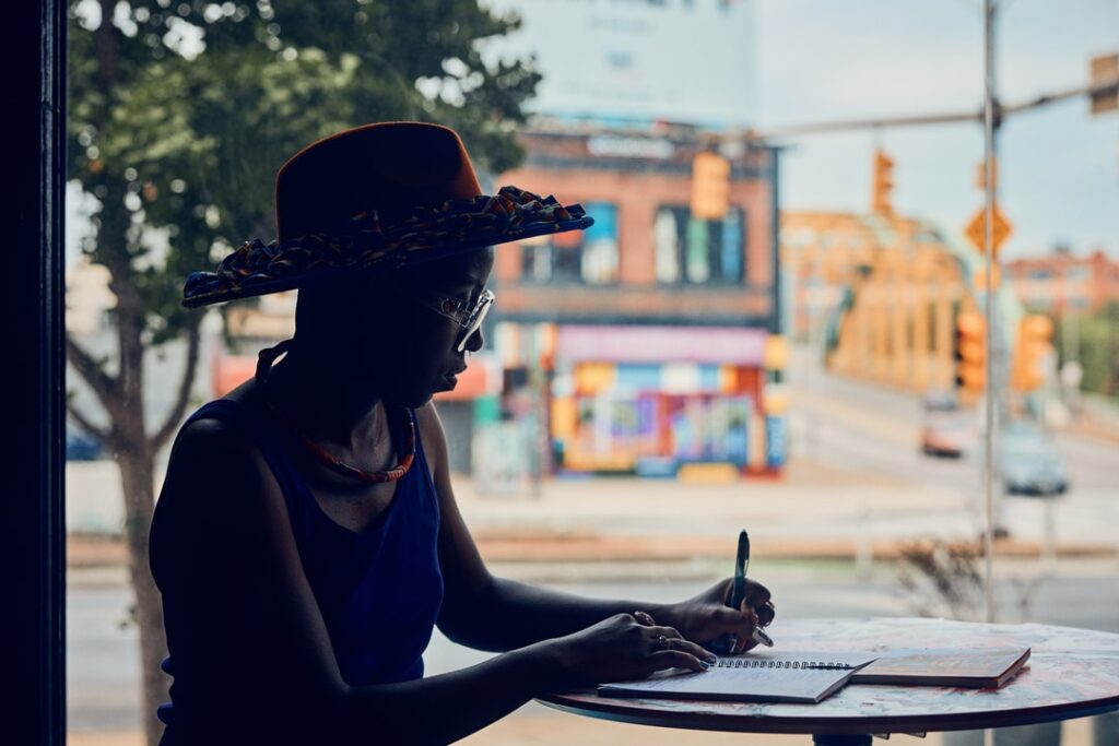 person at table writing