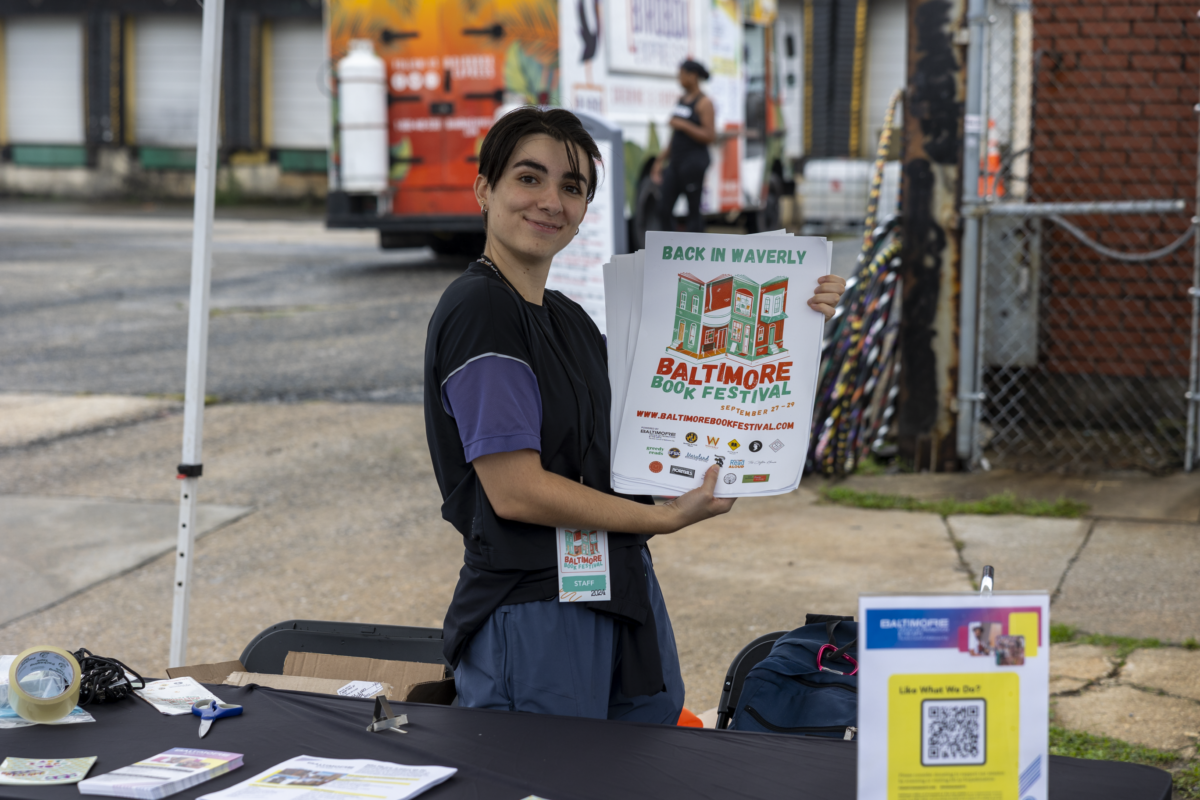 A volunteer holds a sign for the 2024 book festival