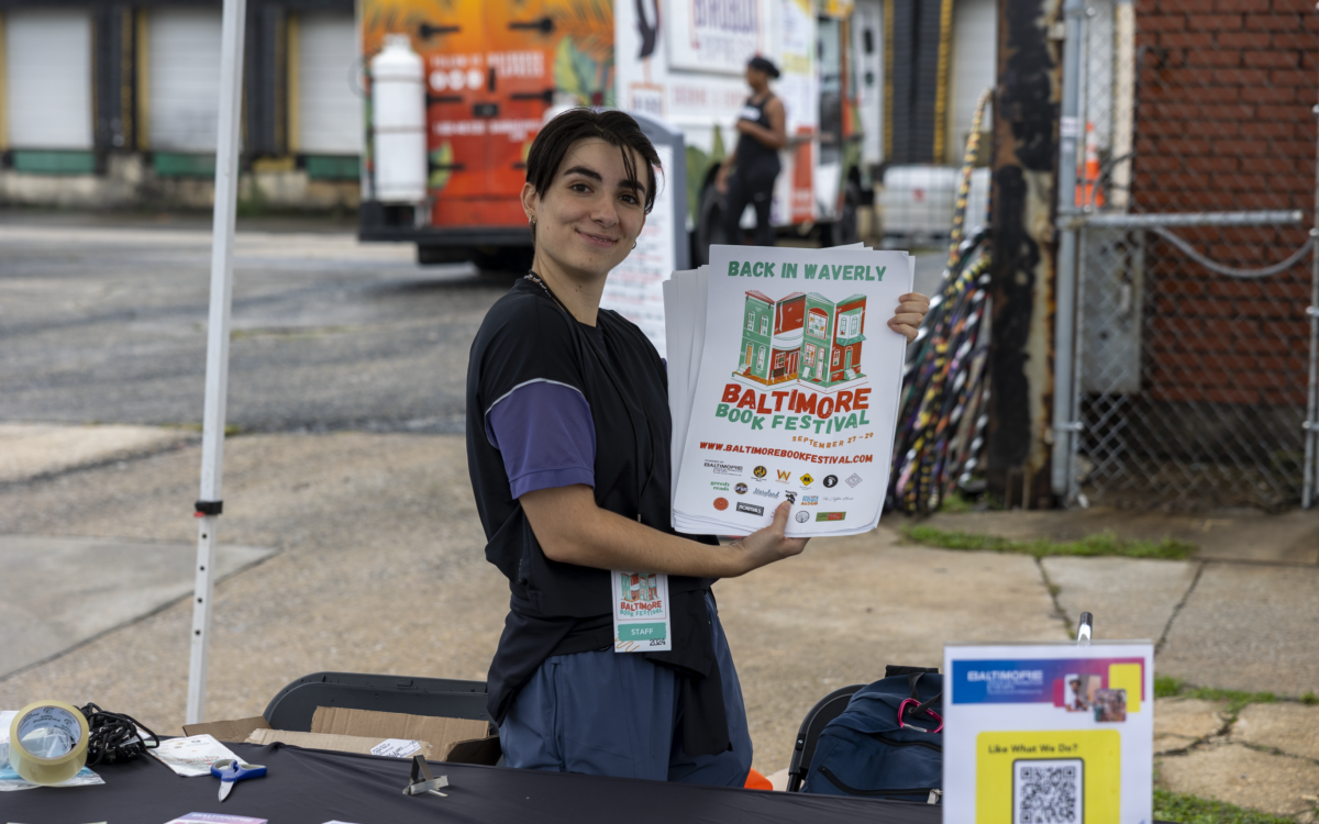 A volunteer holds a sign for the 2024 book festival