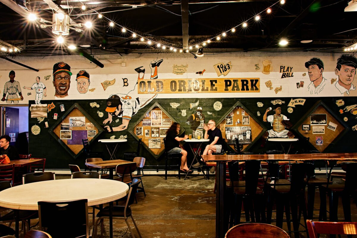 Wide shot of a brewery's taproom decorated with Oriole gear