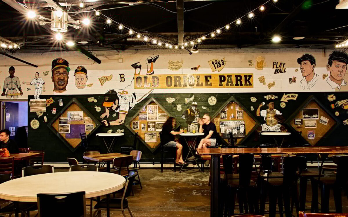 Wide shot of a brewery's taproom decorated with Oriole gear