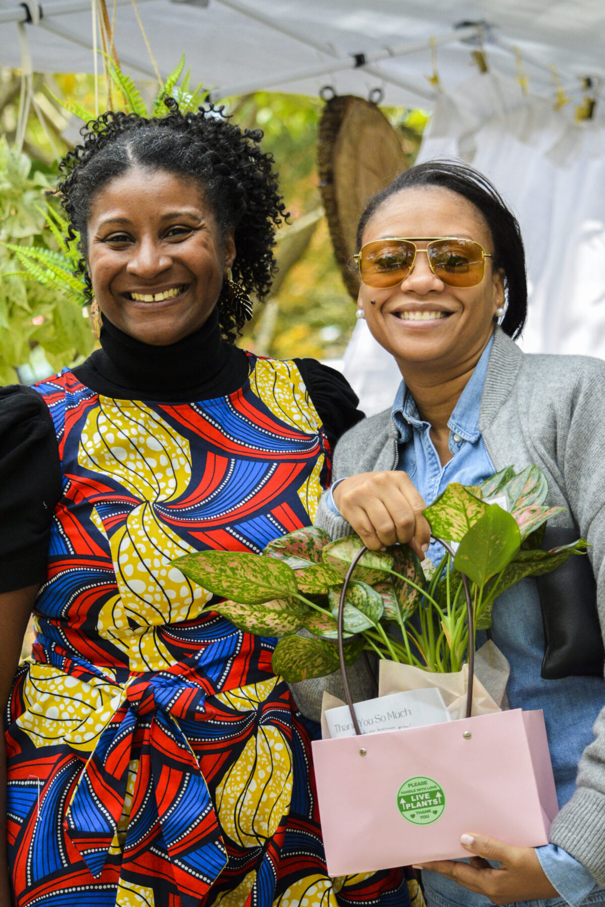 Gardenista Creations owner, Kristin Sparkman, shown with a customer at a local event where she was featured as a vendor.