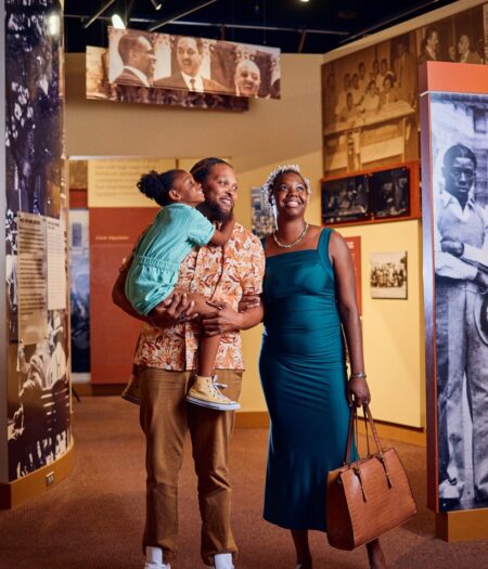 A Black family look at exhibits in the Lewis Museum