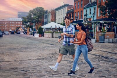 two people crossing the street in fells point
