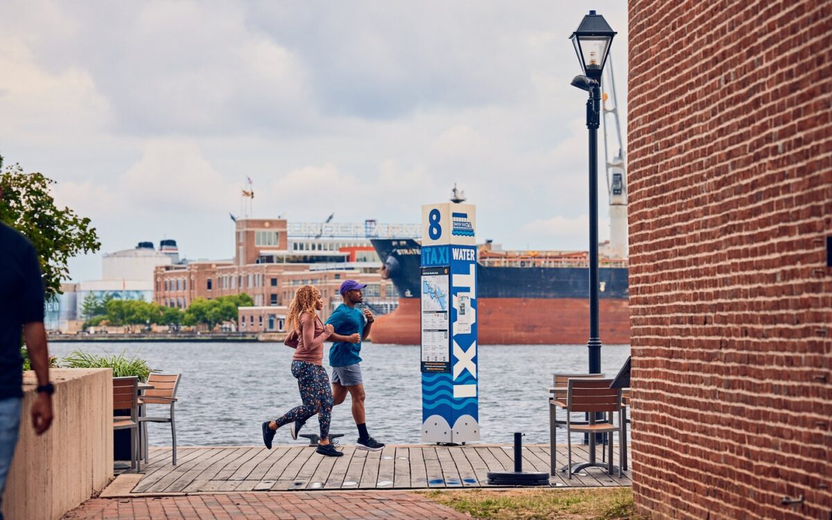 Two people running along the water